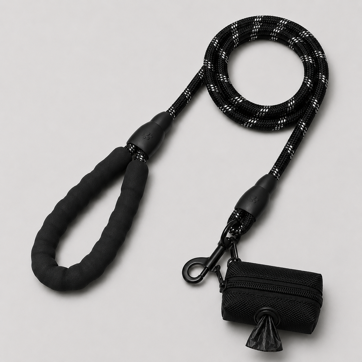 Black dog leash with a dog waste pouch on a light gray background
