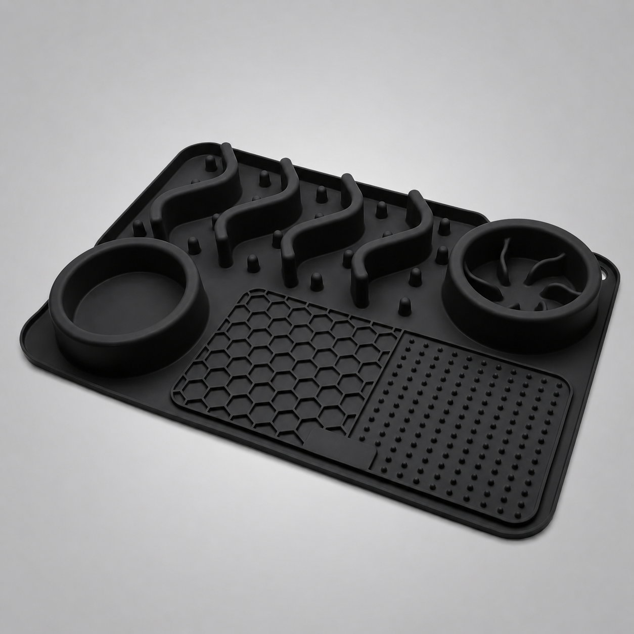 Black silicone mat with two round bowls on a grey background