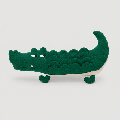 Green crocodile toy on a light grey background