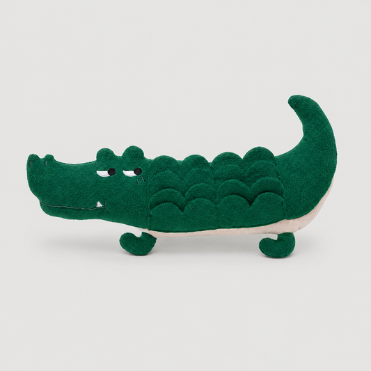 Green crocodile toy on a light grey background