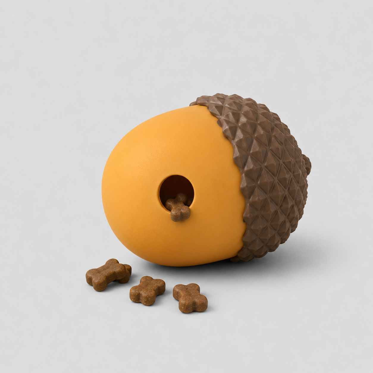 Dog toy shaped like an acorn with a hole on a light grey background