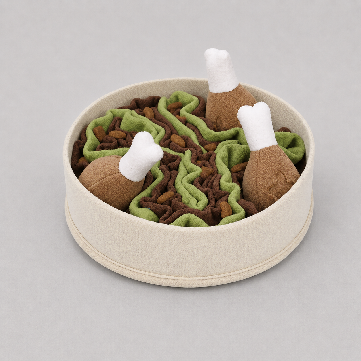 Pet toy set with brown chicken drumsticks and green and brown fabric pieces with dog treats throughout on a light grey background