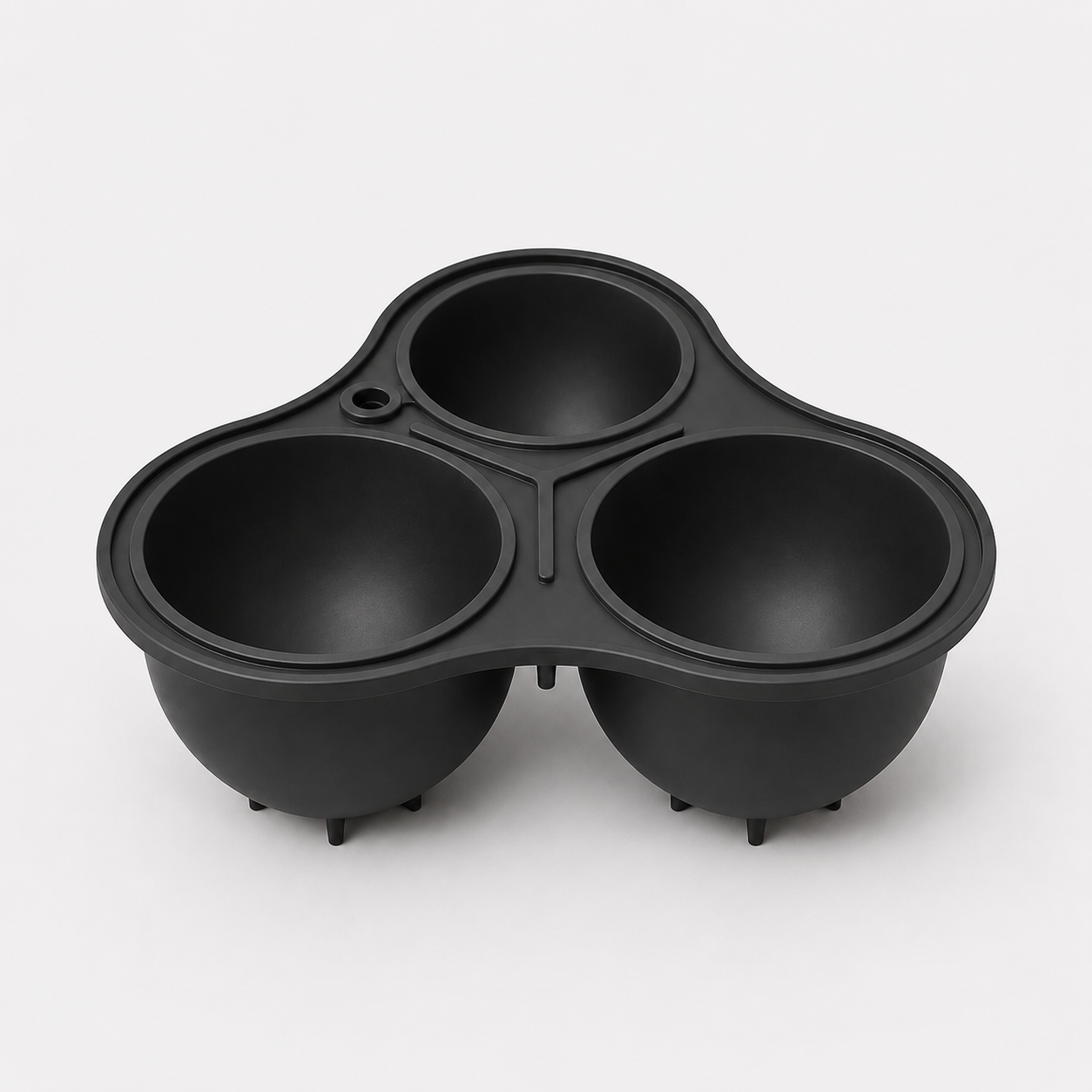 Charcoal three-compartment mould on a light gray background