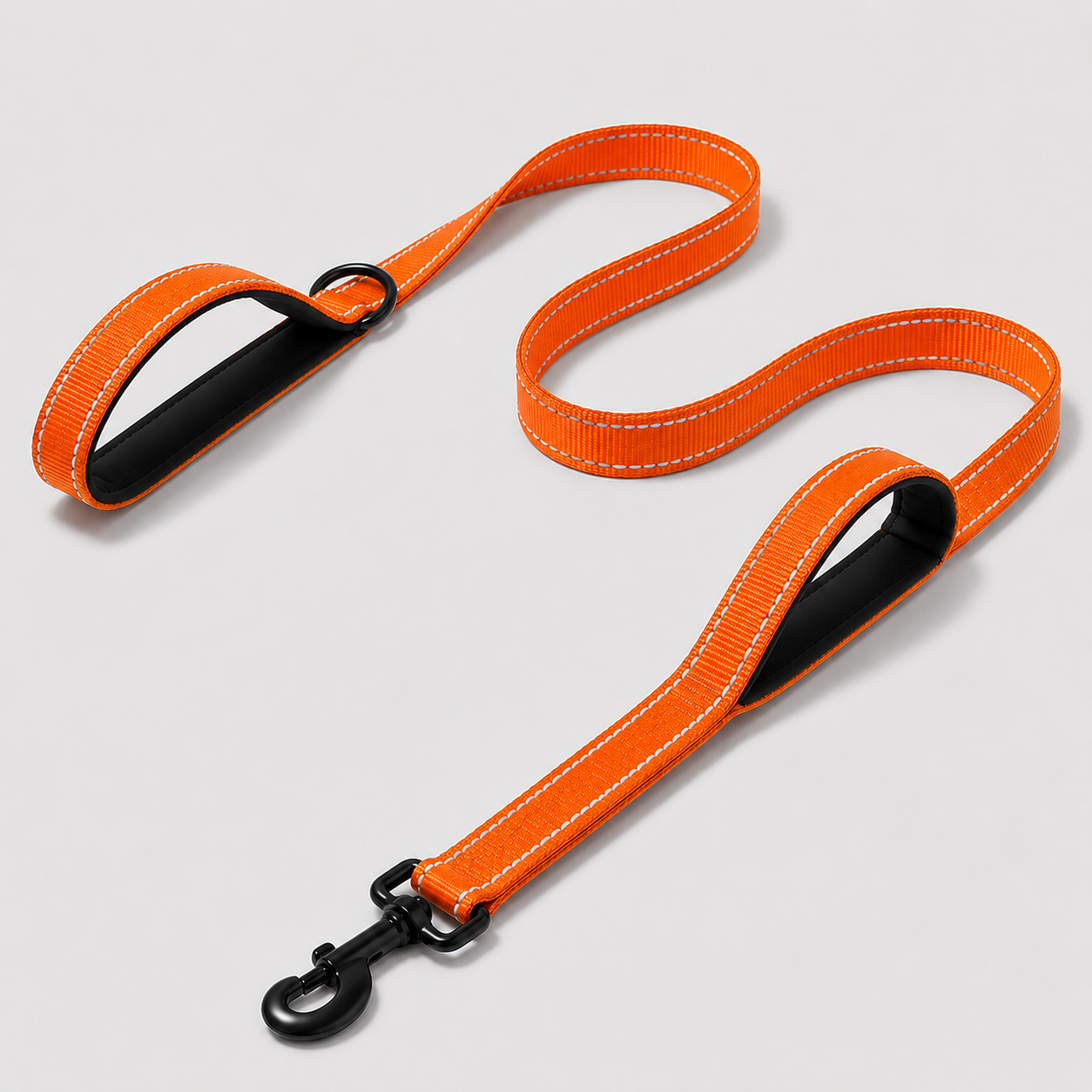 Orange dog leash with black clip on a light grey background