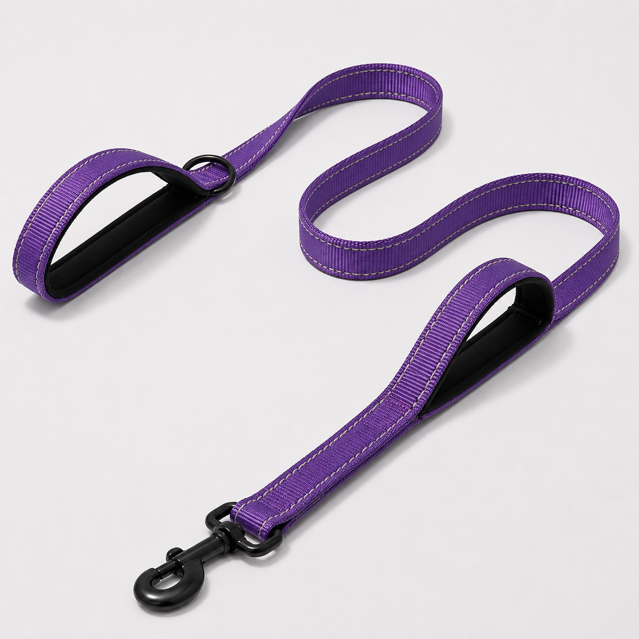 Purple dog leash with black clip on a light grey background
