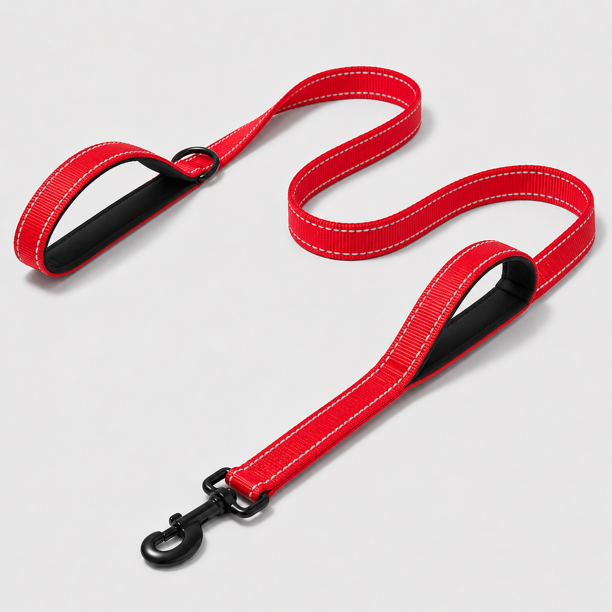 Red dog leash with black clip on a light grey background