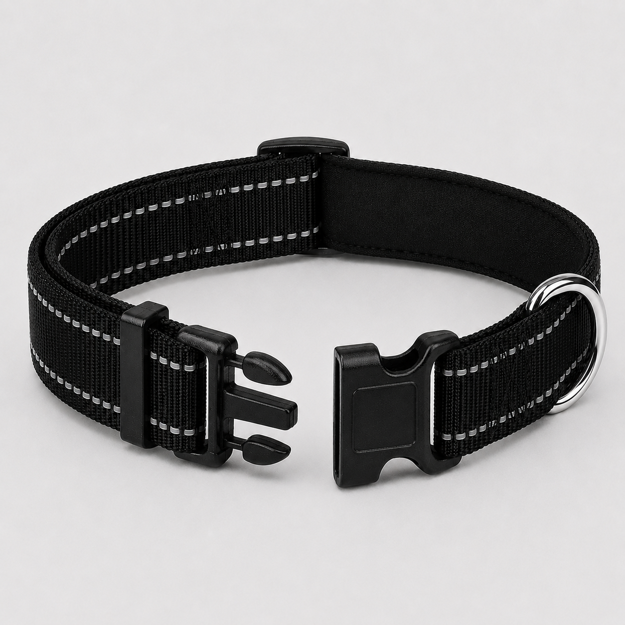 Black dog collar with reflective stripes on a light grey background