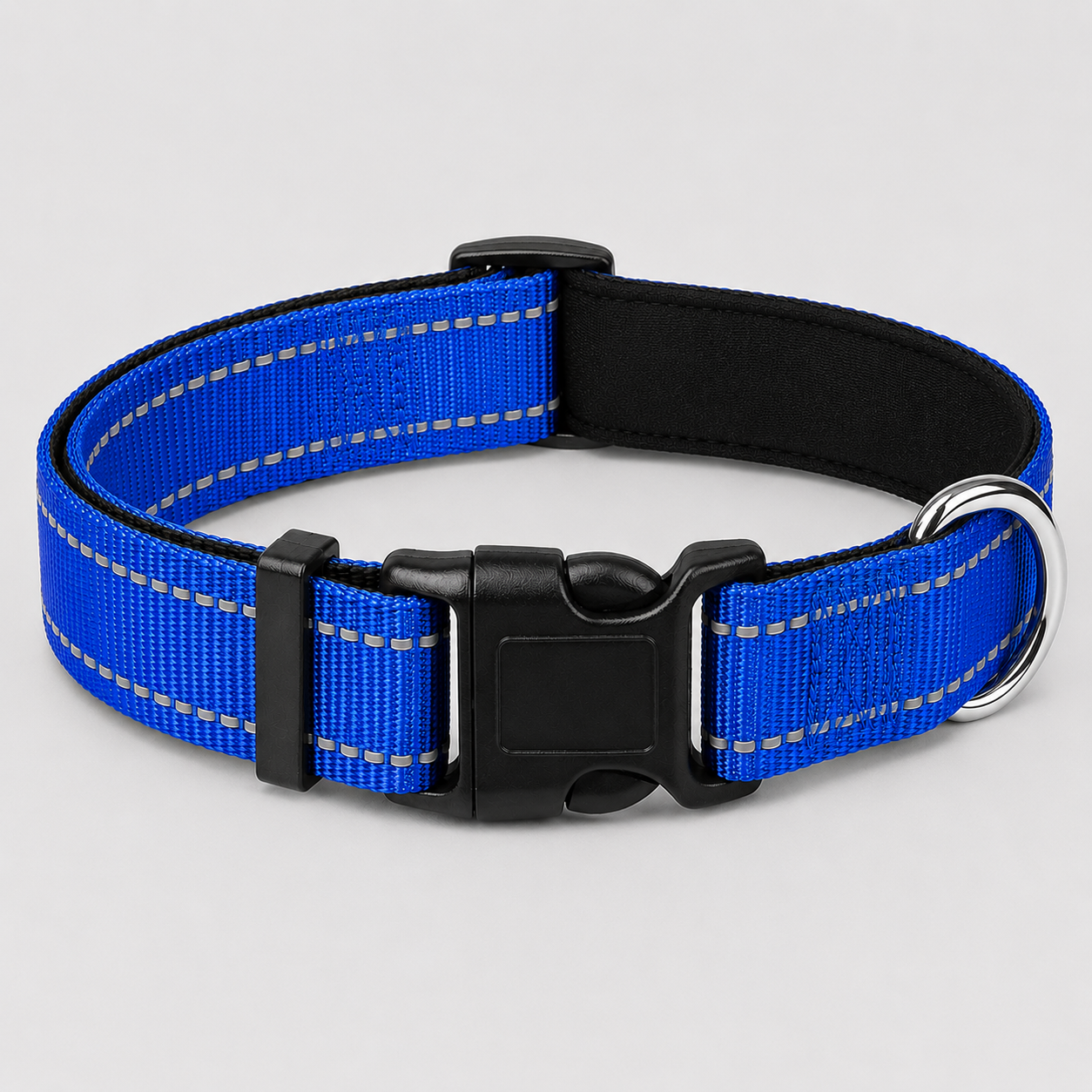 Blue dog collar with black buckle on a light grey background