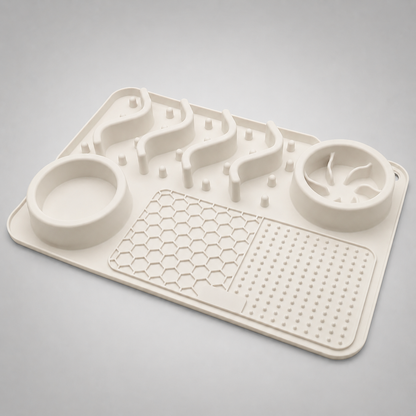 White silicone mat with pet feeding and water bowls on a gray background
