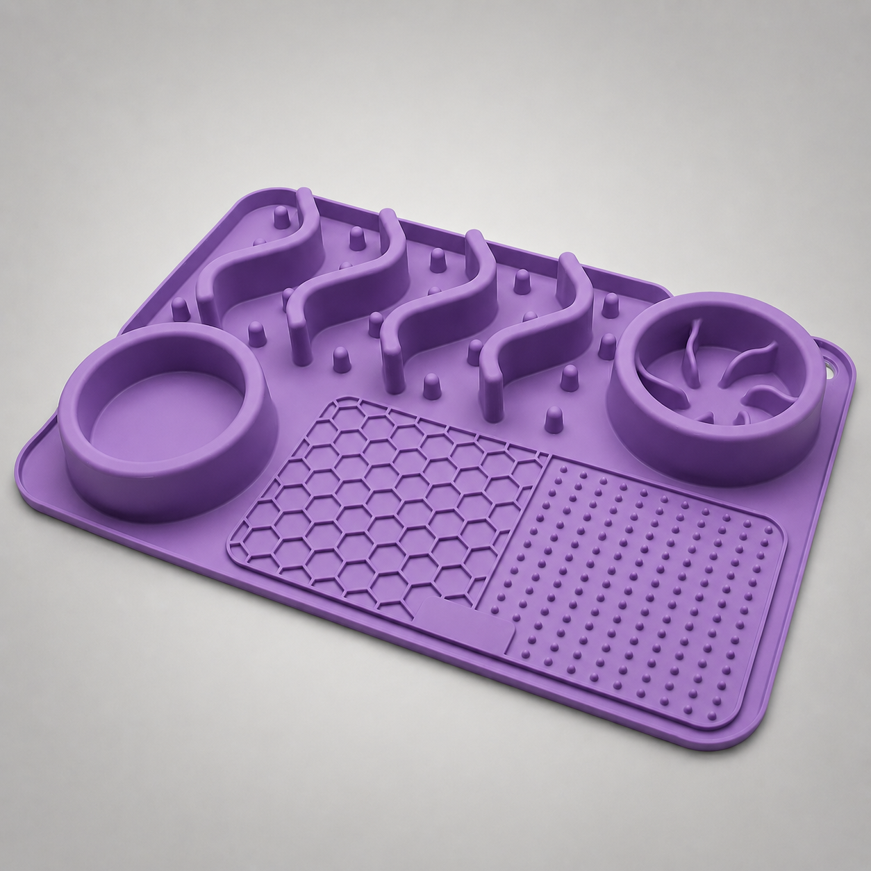 Purple silicone mat and bowls with textured design on a grey background