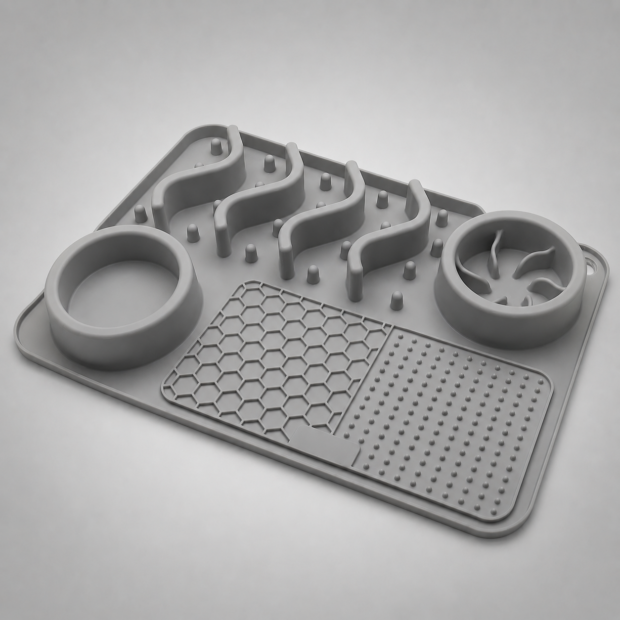 Grey silicone mat with various textured sections on a light grey background