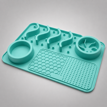Teal silicone mat with raised sections and two circular depressions on a grey background