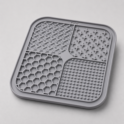 Grey dog lick silicone mat with textured surface on a light gray background