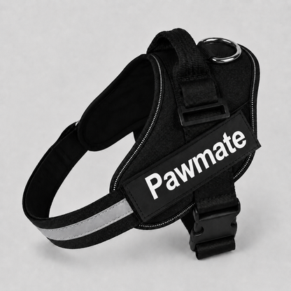 Black dog harness with reflective strip on a gray background