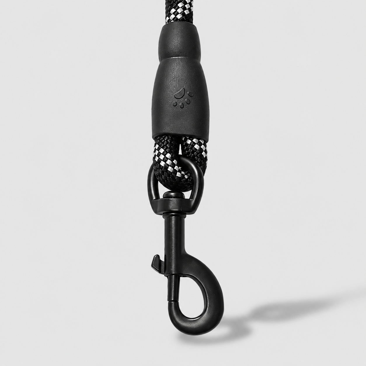 Black dog leash with metal clasp on a light gray background