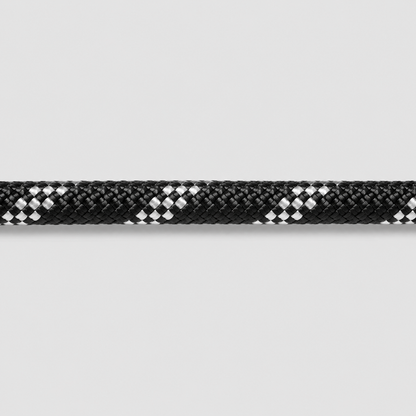 Close-up of a black and white braided rope on a light gray background