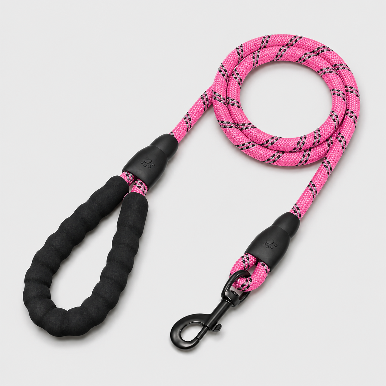 Pink and black dog leash on a light gray background