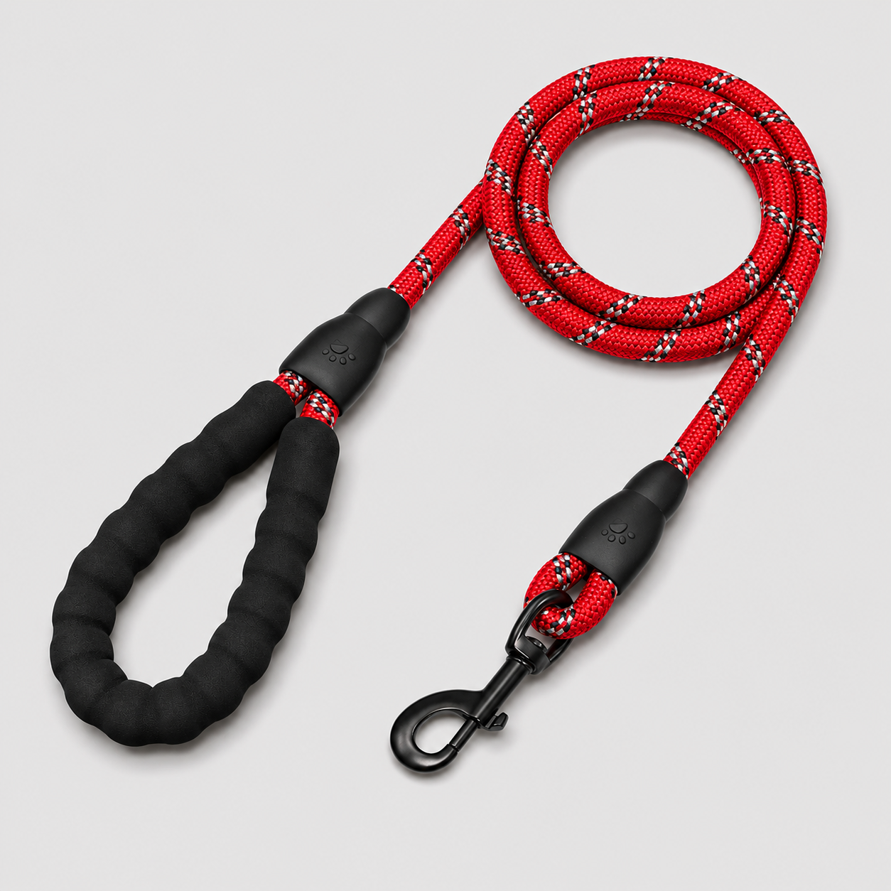 Red and black braided dog leash on a light gray background