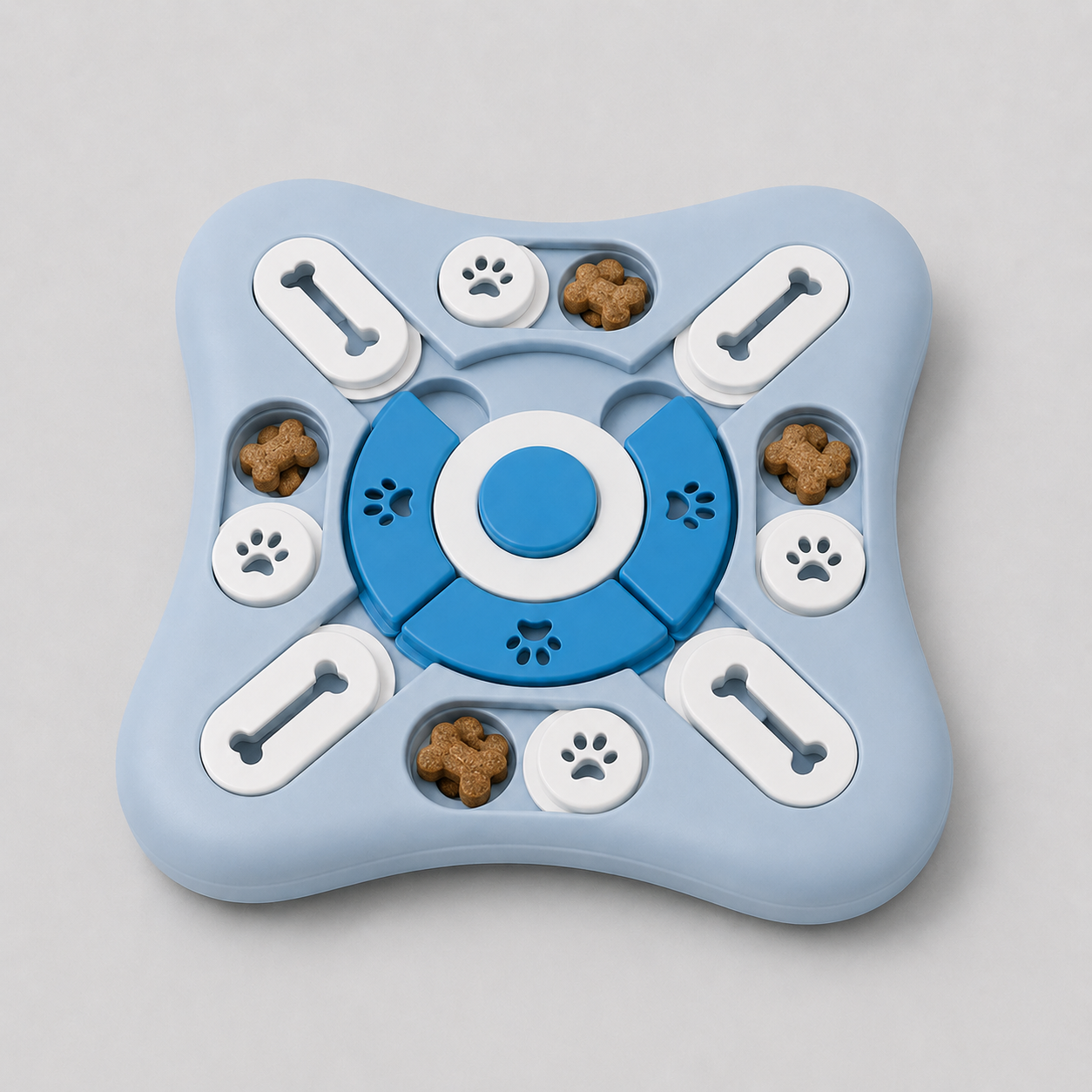 Blue and white puzzle toy for dogs with dog treats on a grey background