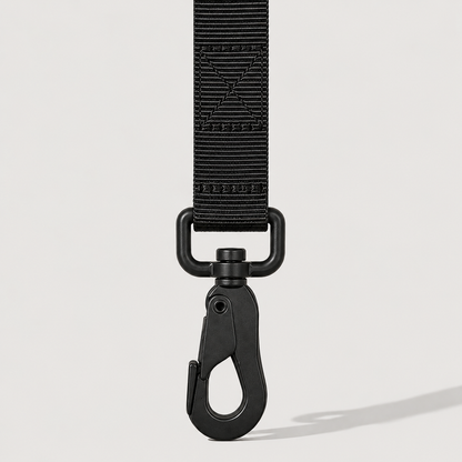 Black dog leash with clip on a light grey background