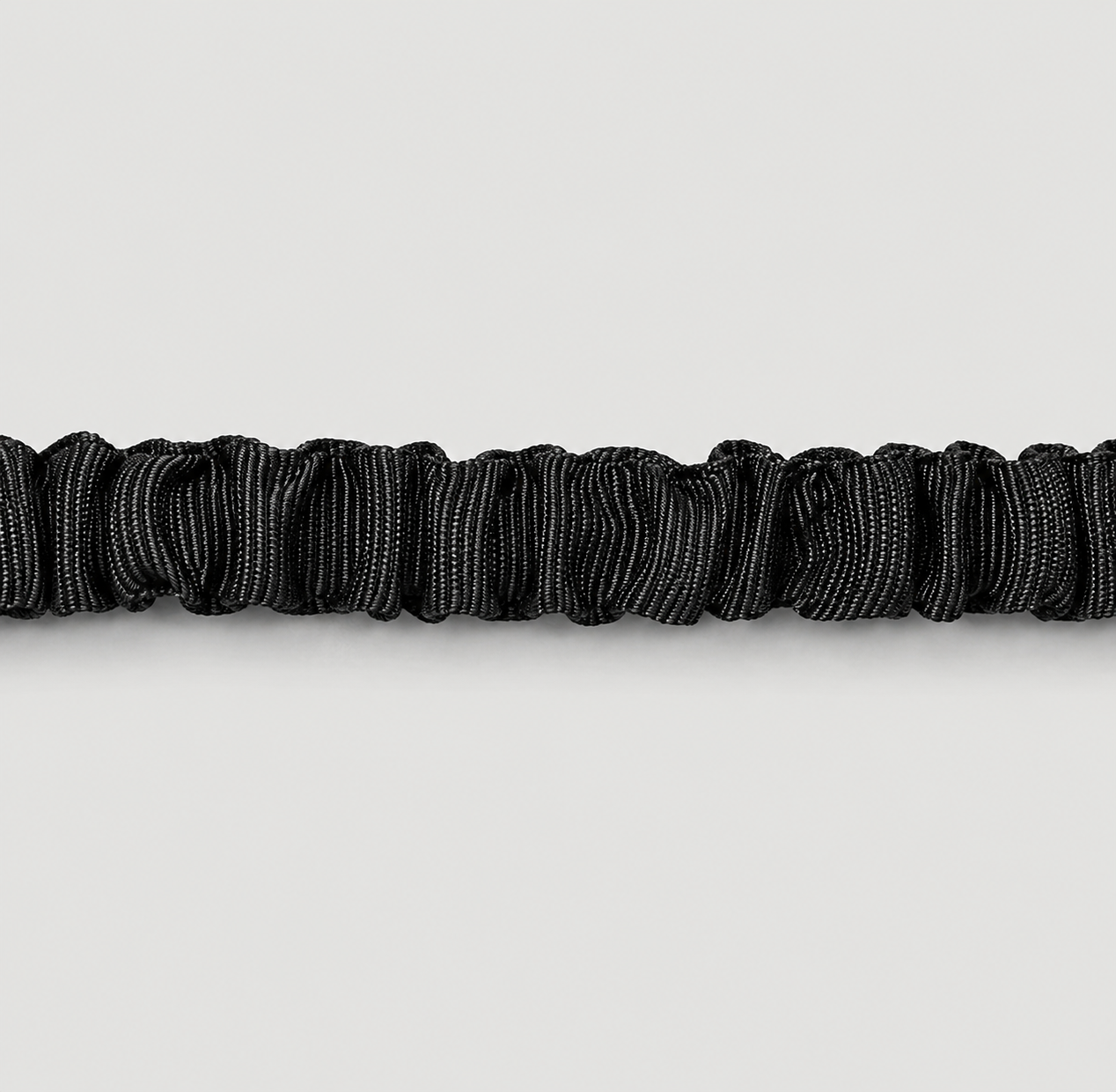 Zoomed in of shocked absorbing leash showing black elastic on a light grey background