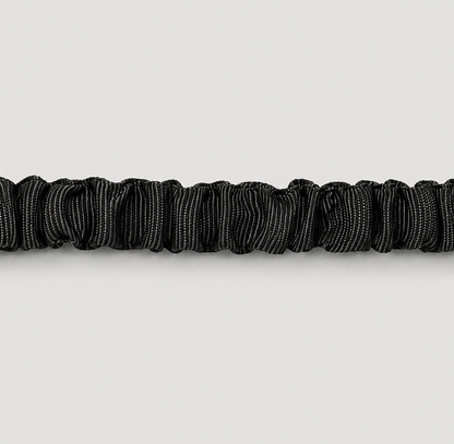 Zoomed in of shocked absorbing leash showing black elastic on a light grey background