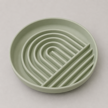 Sage green dog slow feeder bowl with a wavy design on a light gray background