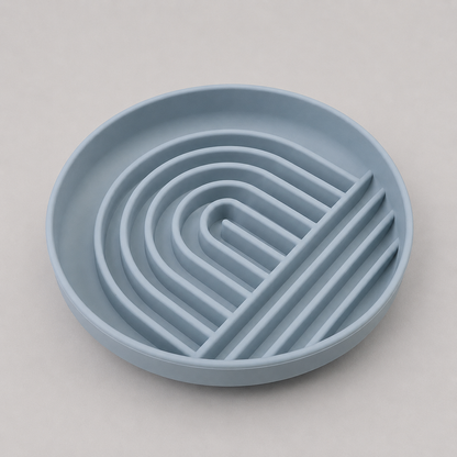 Blue silicone trivet with wavy design on a light gray background