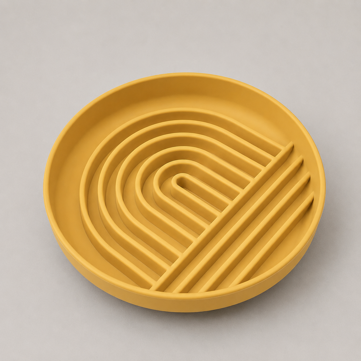 Tumeric dog slow feeder bowl with a wavy pattern on a gray background