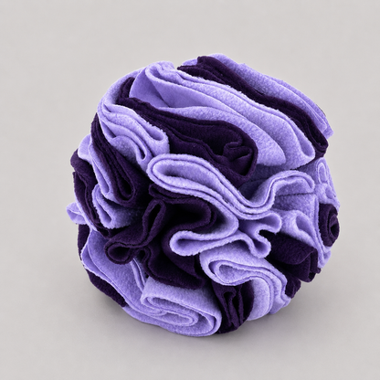 Purple and black textured ball on a grey background