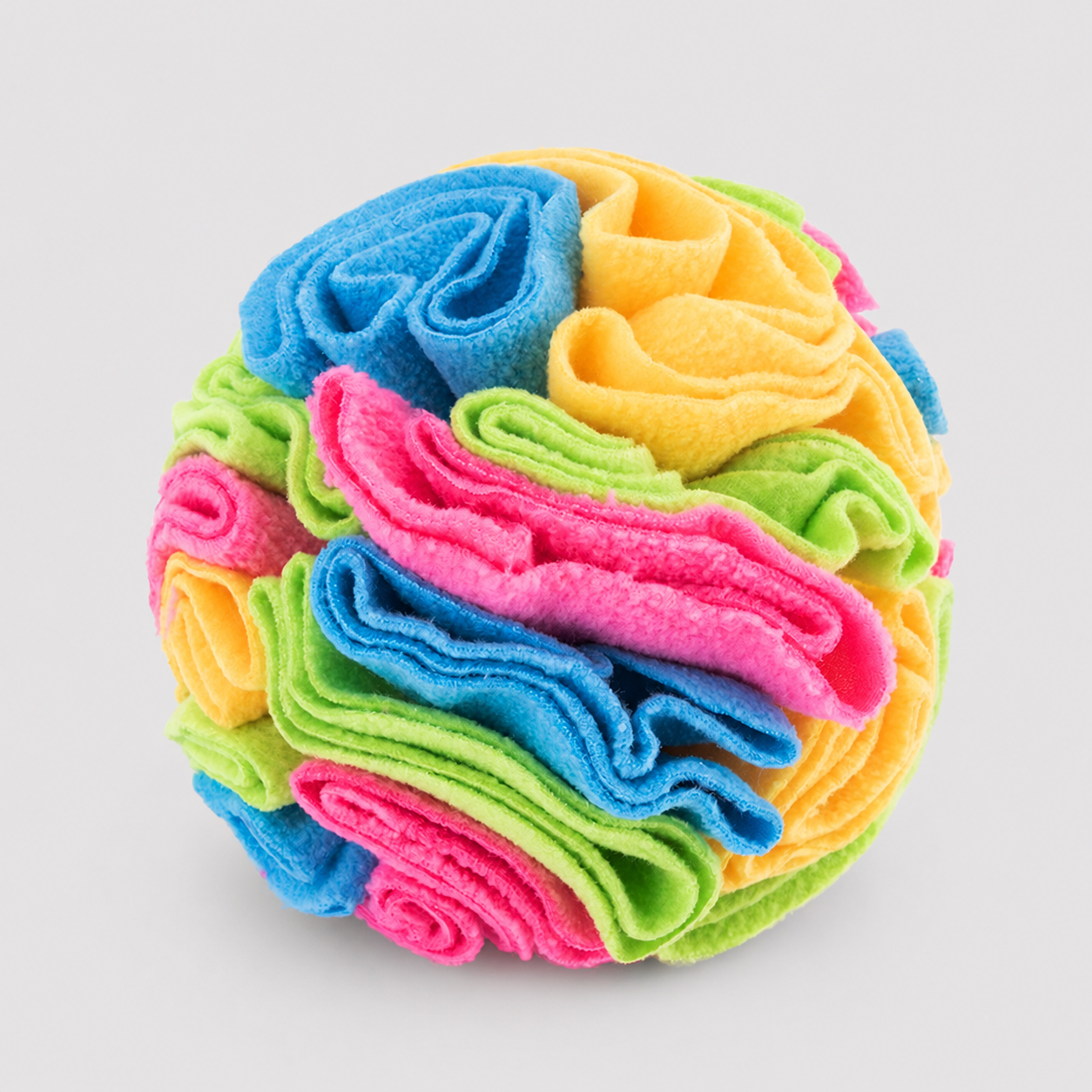 Colorful stack of folded cloths on a light grey background