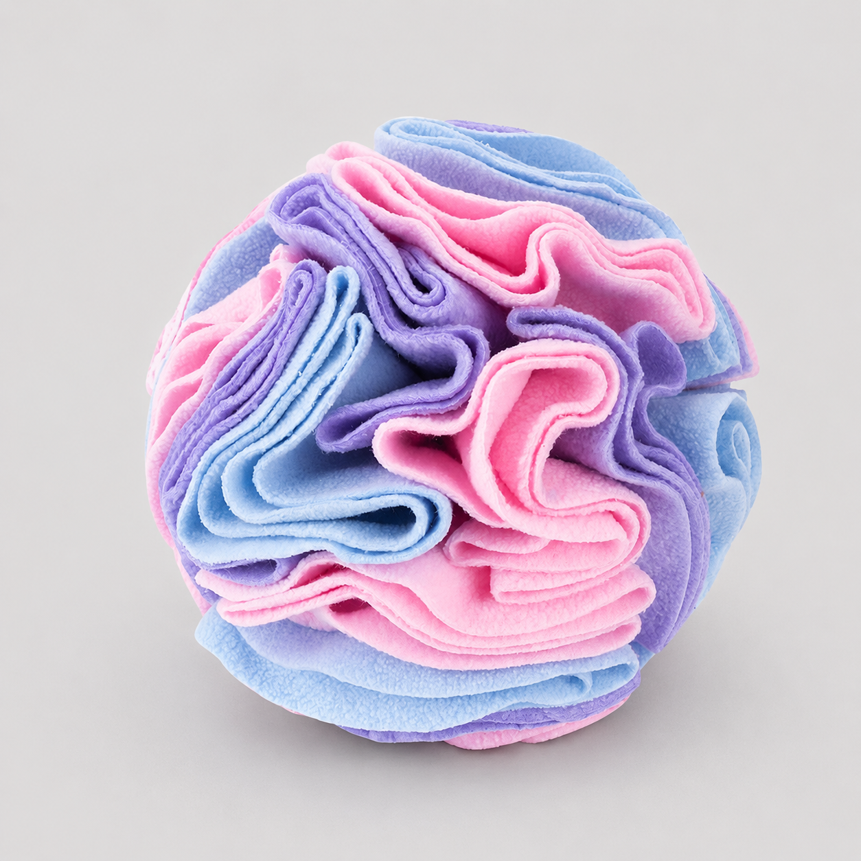 Ball of pink and blue fabric on a light grey background