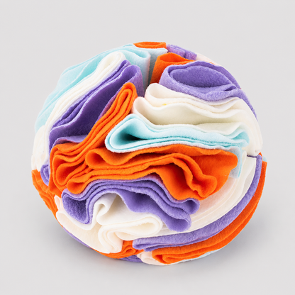 Colorful stack of folded fabric on a light grey background