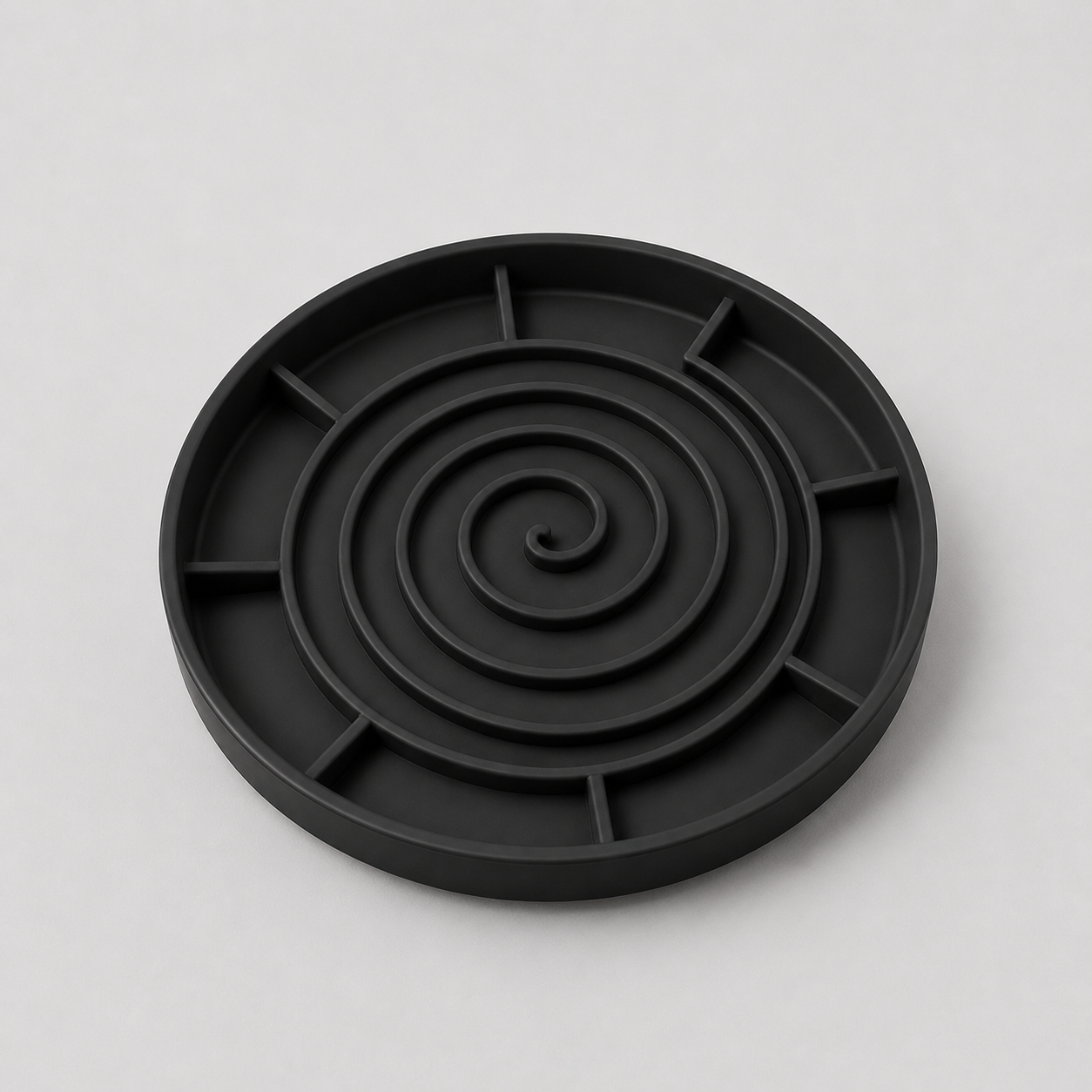 Black silicone slow feeder dog bowl on a light grey background