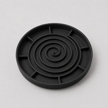 Black silicone slow feeder dog bowl on a light grey background